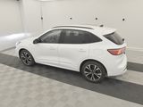 the rear end of a white car parked in a garage