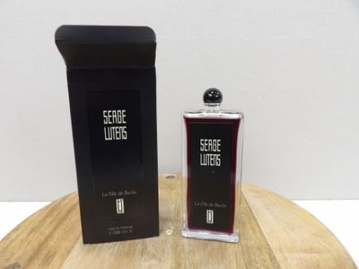 a bottle of perfume sitting on a table next to a box of perfume