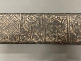 an image of a metal box with carvings on it