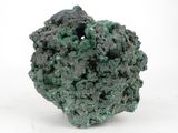 a close up of a piece of green rock on a white surface