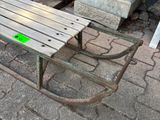 a bench that is sitting on the ground next to a table