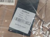 a label on a shirt that is wrapped in plastic