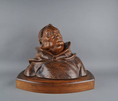 statue of a man with a hat on a wooden base