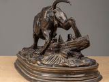 an image of a bronze statue of a dog on a log