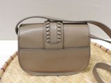 the small purse is sitting on top of a wicker basket