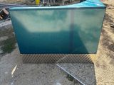 an image of a blue couch sitting in a yard