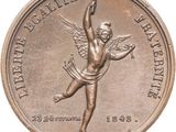 an image of a bronze medal with a winged figure on it