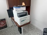 a printer sitting on top of a desk in a room
