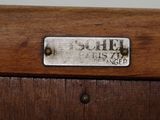 a close up of a metal plate on a wooden cabinet