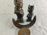 a bronze statue of a man and a cat sitting on a crescent