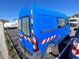 a blue van that is parked in a parking lot