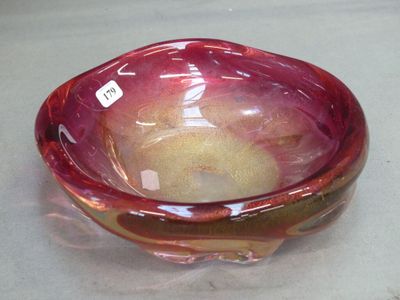 a glass bowl with a red and yellow design on it