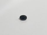 a close up of a small black object on a white surface