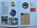 an open book with pictures of various military badges on it