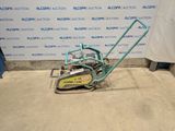 a machine that is sitting on the ground in front of a wall
