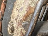 a close up of a metal object with a face on it