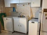 a small kitchen with a washer and dryer in it