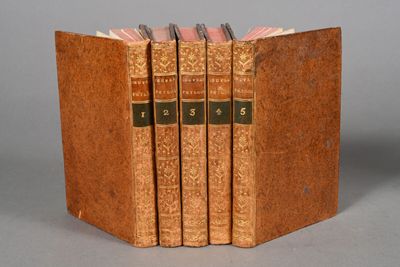 three books are stacked on top of each other on a table
