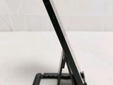 a tablet that is sitting on a stand on a table
