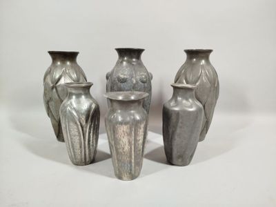 four vases that are sitting on a white surface