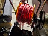 a small cart with a hose and a reel on it