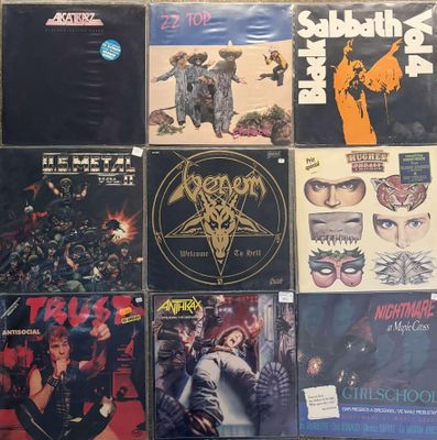 many different types of rock and metal albums on the wall