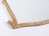 a mirror that is shaped like a tree branch