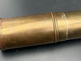 a close up of a brass cylinder on a black surface