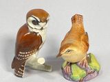 two figurines of birds sitting on top of each other