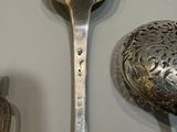 two spoons that are sitting next to each other