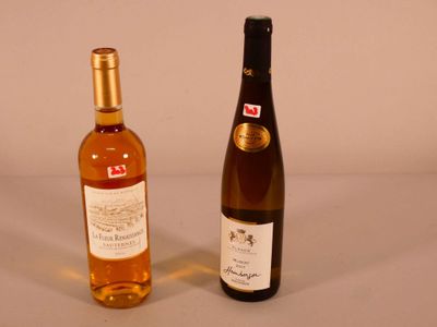 two bottles of wine sitting next to each other on a table