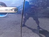 a reflection of a man on the side of a blue car
