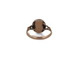 a close up of a ring with a brown stone on it