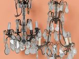 two chandeliers hanging from the ceiling in a room with orange walls