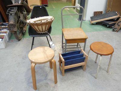 three stools and a chair in a room