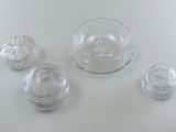 four glass dishes and a bowl sitting on a table