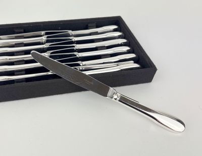 silverware in a black box on a white surface with a knife