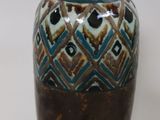 a brown and blue vase with a tag on it