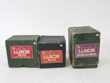 three boxes of liquor sitting next to each other on a white surface