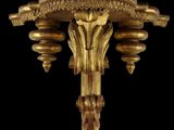 an image of a gold plated wall sconce on a black background
