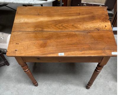 a small wooden table with a label on it