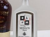 a bottle of rum next to a bottle of liquor on a table