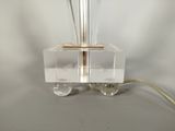 a clear glass lamp with a wooden base and a metal base