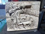 une statue représentant un homme armé d'un fusil et accompagné d'un chien