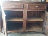 an old wooden cabinet with two drawers and a door