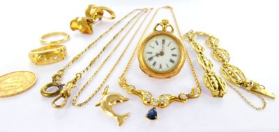 a lot of gold jewelry on a white surface