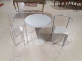 three chairs and a table in the middle of a room