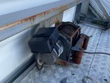 a pile of luggage sitting on the ground next to a garage door