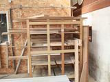 a pile of wood in the middle of a room that is being built