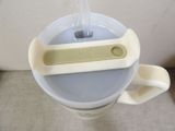 a plastic cup with a plastic handle and a plastic cup with a plastic handle
